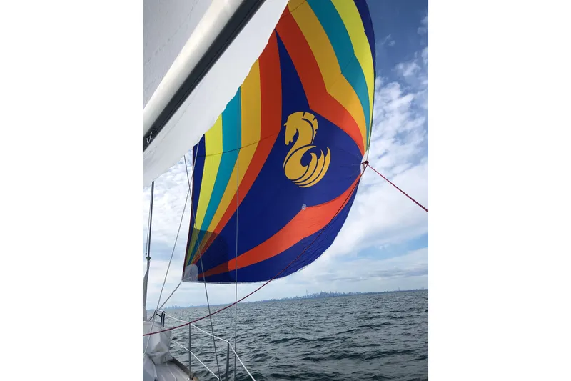 Slide: The Image of Colorful sail on 2008 Beneteau 31 yacht against ocean and skyline backdrop. - 76