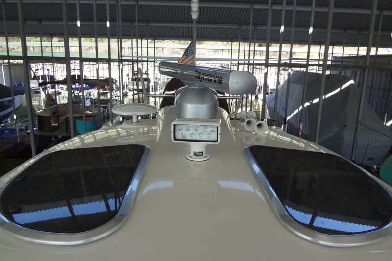 Slide: The Image of 2019 Formula 400 Super Sport boat in covered storage, featuring radar and navigation equipment. - 34