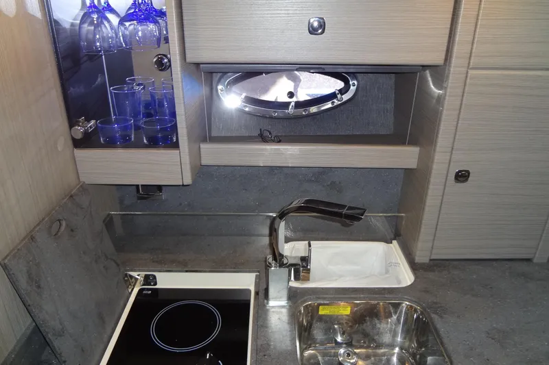 Slide: The Image of 2019 Formula 400 Super Sport yacht kitchen with sink, stove, and glassware cabinet. - 39