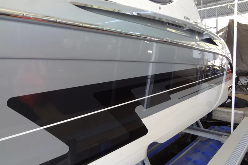 Slide: The Image of 2019 Formula 400 Super Sport boat with sleek black and white design in a showroom. - 7