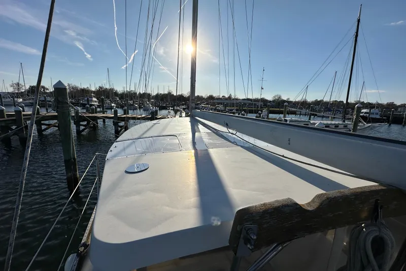 Slide: The Image of 1978 CSY 44 Cutter Rig sailboat docked in a sunny marina. - 11