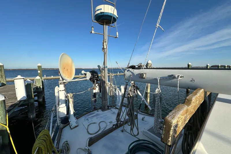 Slide: The Image of 1978 CSY 44 Cutter Rig sailboat docked, featuring rigging and marine equipment. - 12