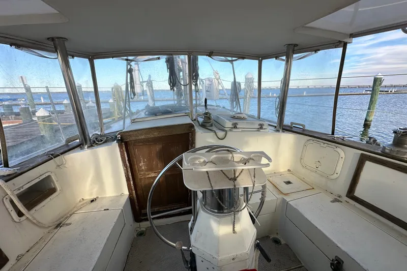 Slide: The Image of Cockpit of 1978 CSY 44 Cutter Rig sailboat with steering wheel and ocean view. - 13