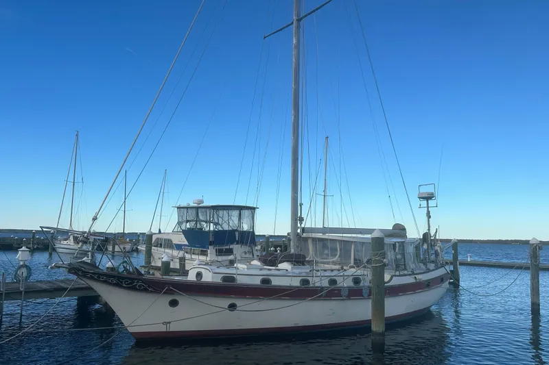 Slide: The Image of 1978 CSY 44 Cutter Rig sailboat docked at marina under clear blue sky. - 14