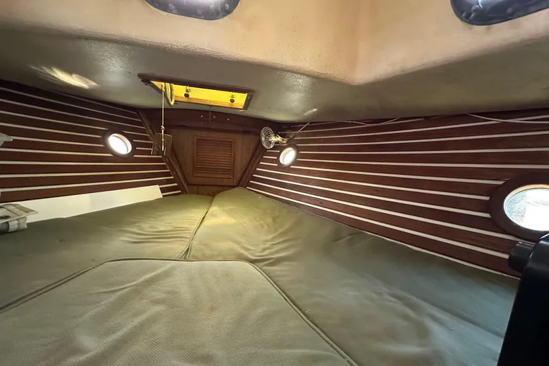 Slide: The Image of 1978 CSY 44 Cutter Rig cabin interior with wood paneling and portholes. - 16