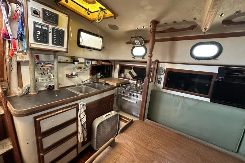 Slide: The Image of Interior of 1978 CSY 44 Cutter Rig sailboat with kitchen and dining area. - 21