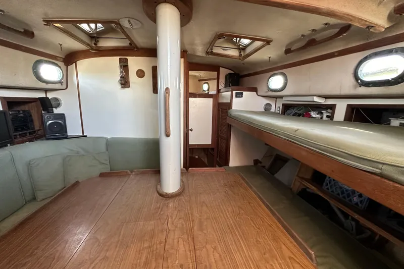 Slide: The Image of Interior of 1978 CSY 44 Cutter Rig sailboat with wood accents and seating area. - 22