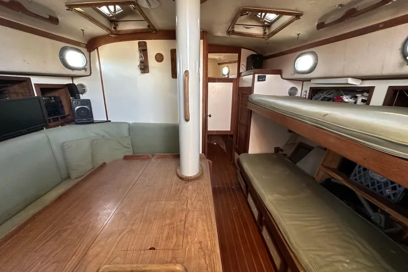 Slide: The Image of Interior of 1978 CSY 44 Cutter Rig sailboat with wooden furnishings and cozy seating. - 23