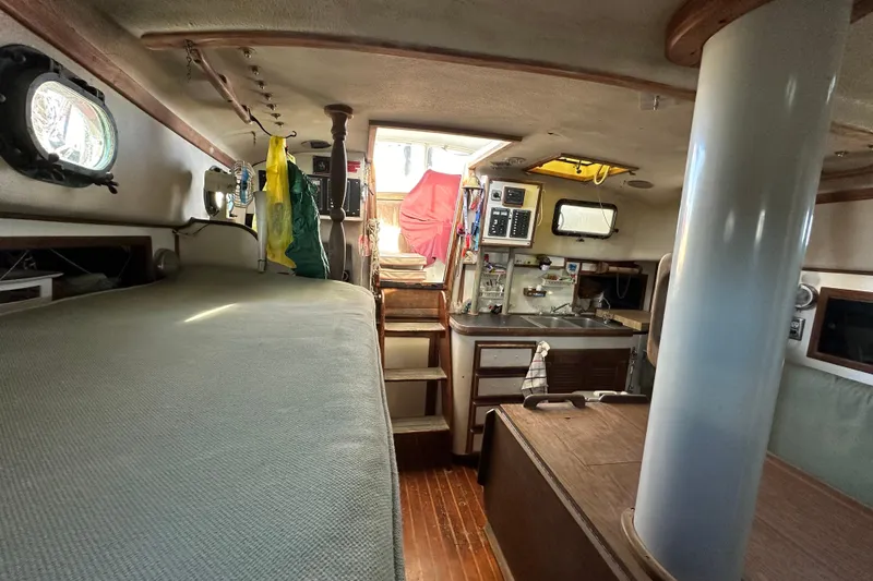 Slide: The Image of Interior of 1978 CSY 44 Cutter Rig sailboat, featuring cozy cabin and compact kitchen area. - 24