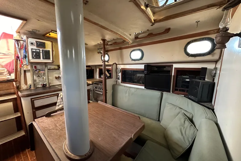 Slide: The Image of Interior of 1978 CSY 44 Cutter Rig sailboat with cozy seating and navigation equipment. - 25