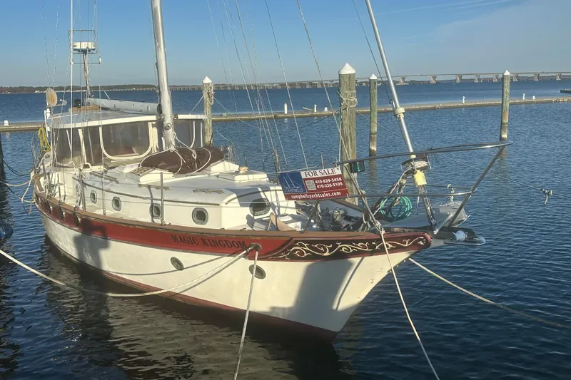 Slide: The Image of 1978 CSY 44 Cutter Rig sailboat docked, "Magic Kingdom," for sale sign visible. - 3