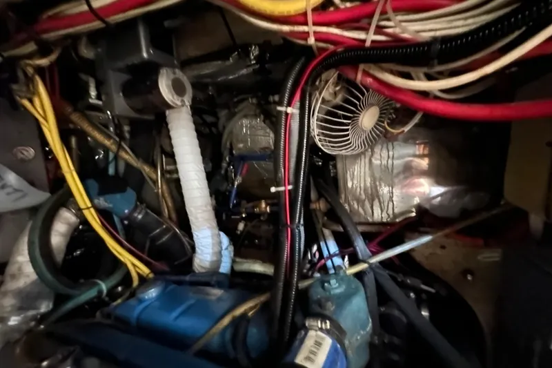 Slide: The Image of Engine compartment of a 1978 CSY 44 Cutter Rig with visible wiring and components. - 33