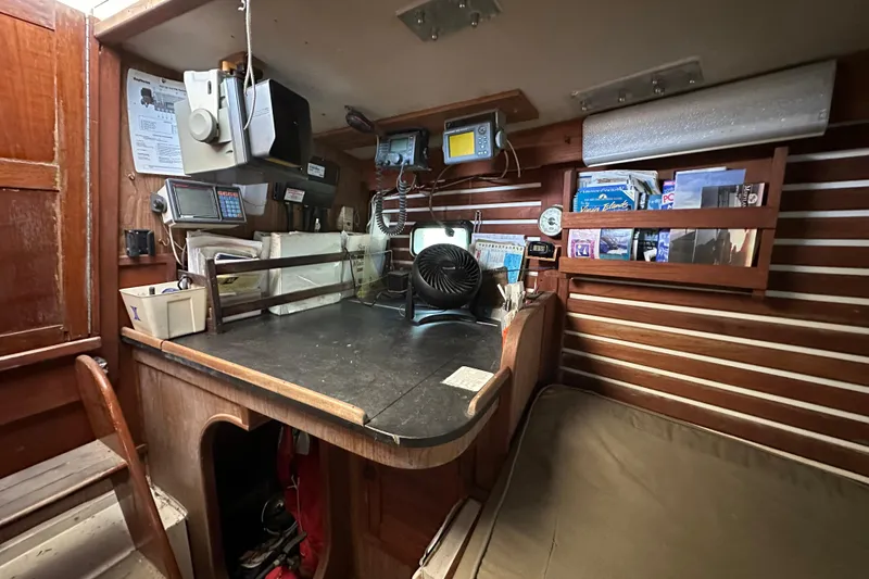 Slide: The Image of 1978 CSY 44 Cutter Rig interior with navigation desk, equipment, and storage shelves. - 37