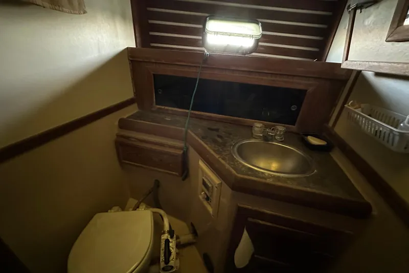 Slide: The Image of 1978 CSY 44 Cutter Rig bathroom with sink, toilet, and wooden cabinetry. - 39