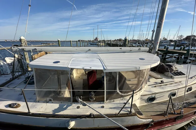 Slide: The Image of 1978 CSY 44 Cutter Rig sailboat docked at a marina under clear blue skies. - 4