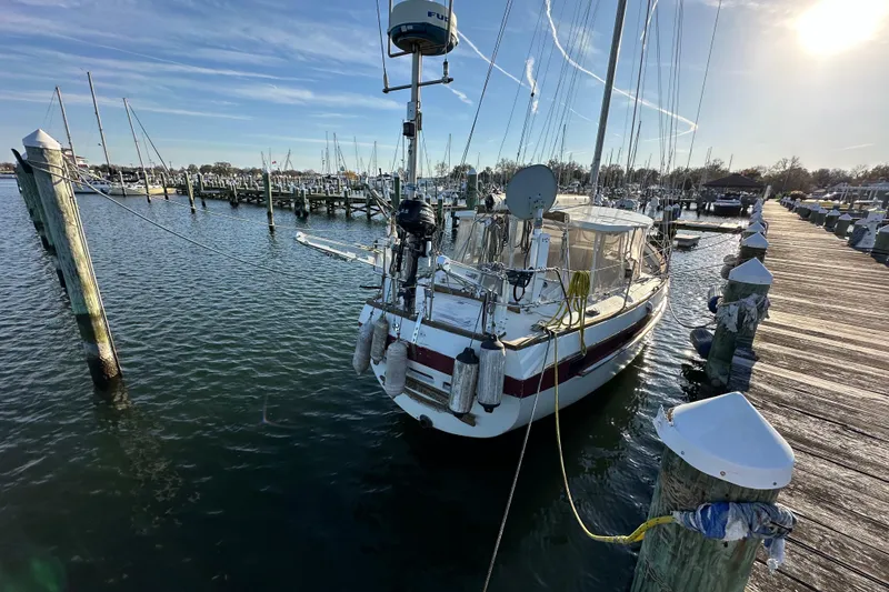 Slide: The Image of 1978 CSY 44 Cutter Rig sailboat docked at a marina under a clear blue sky. - 6