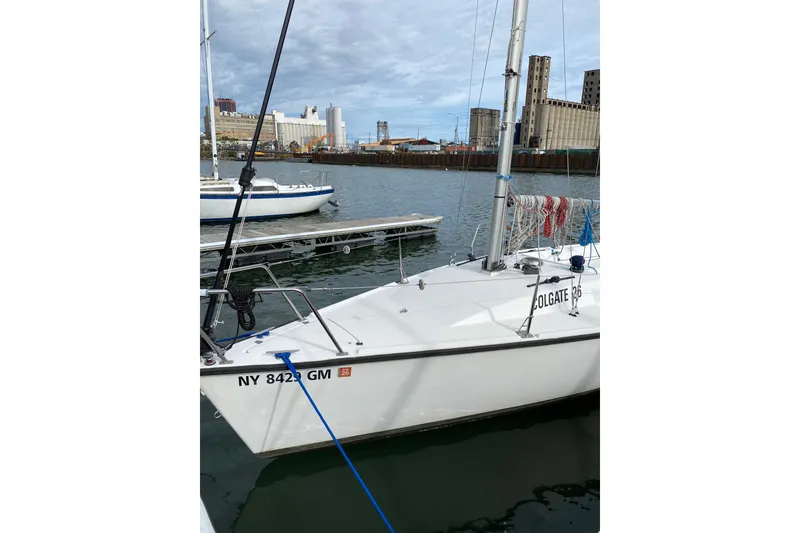 Slide: The Image of Sailboat Colgate 26, 2004 model, docked in an industrial marina setting. - 4