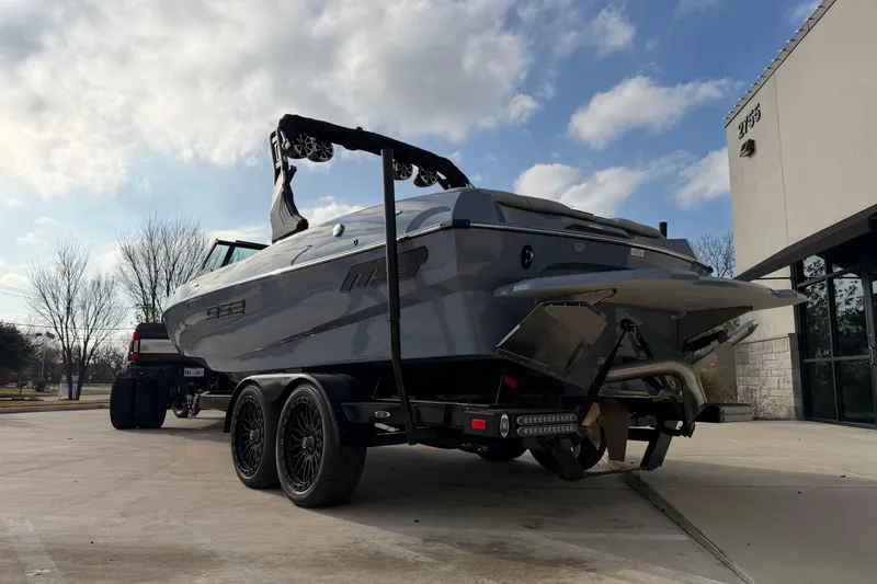 Slide: The Image of 2026 MB B52 23 Classic boat on trailer, parked outdoors under a cloudy sky. - 4