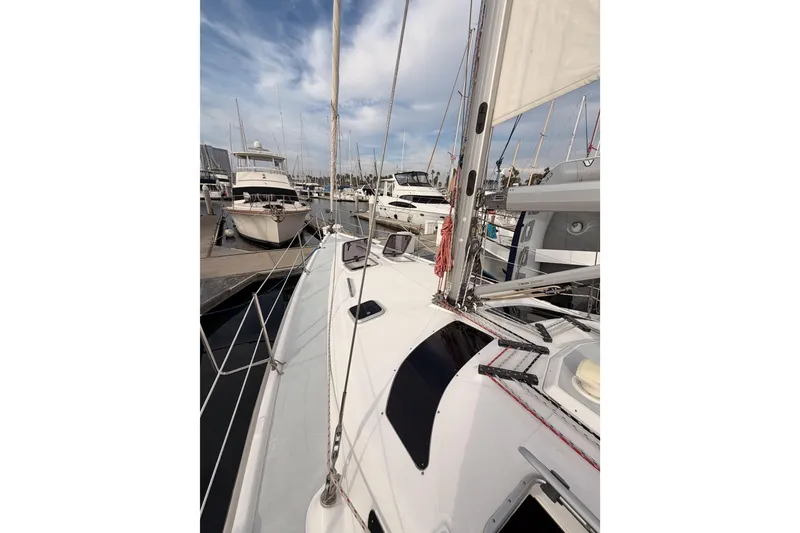 Slide: The Image of Sailboat docked at marina, Hunter 460 model, 2002, with clear sky and surrounding boats. - 12