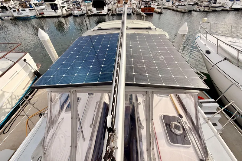 Slide: The Image of Hunter 460 sailboat with solar panels docked at marina, 2002 model. - 17
