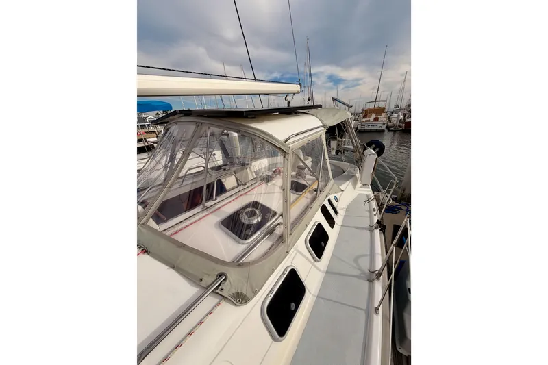 Slide: The Image of 2002 Hunter 460 sailboat docked at marina under cloudy sky. - 18