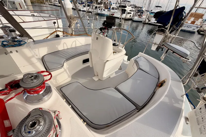 Slide: The Image of Cockpit of 2002 Hunter 460 sailboat with cushioned seating and marina view. - 19