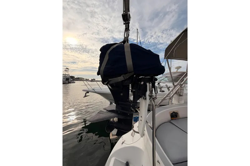 Slide: The Image of Hunter 460 sailboat from 2002 with covered outboard motor at marina. - 23