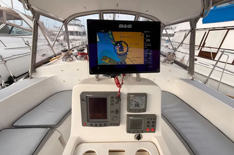 Slide: The Image of Cockpit of 2002 Hunter 460 sailboat with navigation equipment and seating. - 26