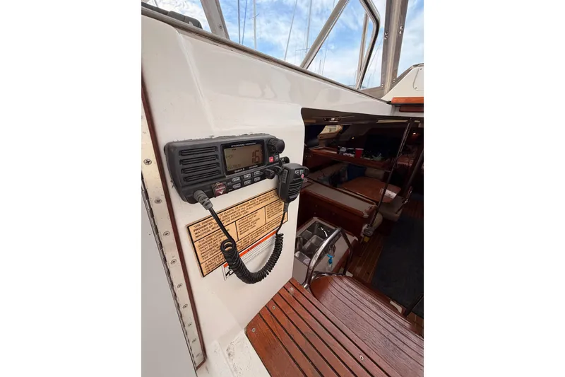 Slide: The Image of 2002 Hunter 460 yacht interior with radio equipment and wooden flooring. - 29