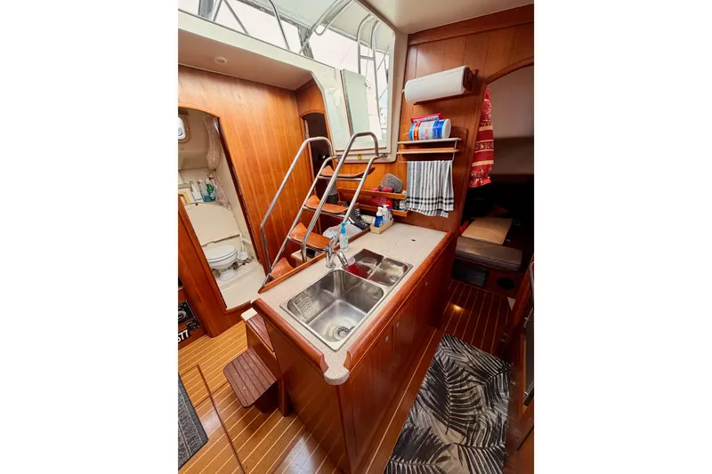 Slide: The Image of Interior of 2002 Hunter 460 yacht with wooden cabinetry and compact kitchen area. - 35