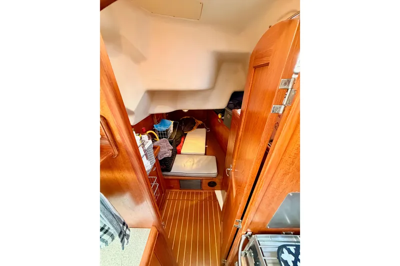 Slide: The Image of Interior cabin of 2002 Hunter 460 sailboat with wooden finishes and cozy sleeping area. - 37