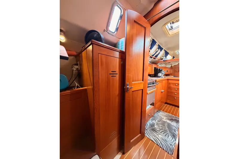 Slide: The Image of Interior of 2002 Hunter 460 sailboat with wooden cabinetry and modern kitchen amenities. - 40