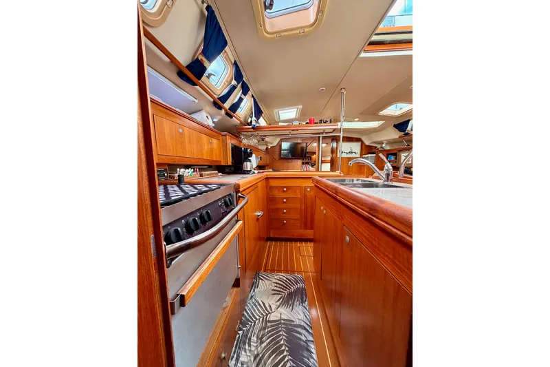 Slide: The Image of Interior of 2002 Hunter 460 yacht with wooden cabinetry and modern kitchen amenities. - 42