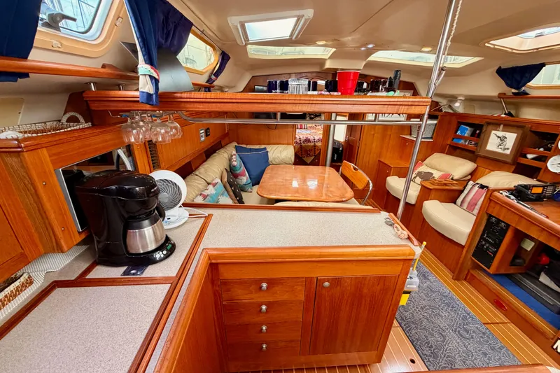Slide: The Image of Luxurious interior of 2002 Hunter 460 yacht with wood finish and cozy seating area. - 45