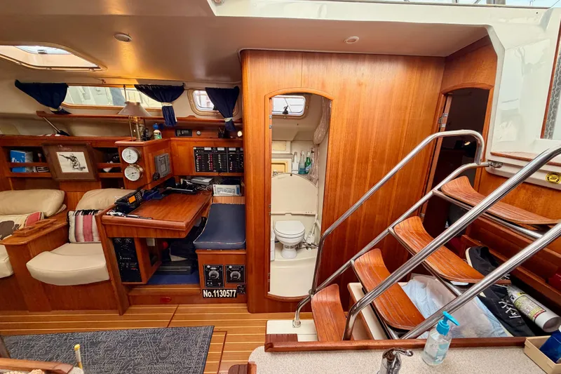 Slide: The Image of Interior of 2002 Hunter 460 yacht with wooden finish, navigation station, and compact bathroom. - 47