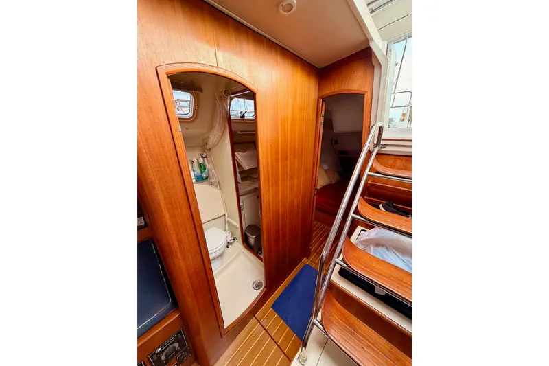 Slide: The Image of Interior of 2002 Hunter 460 yacht showing wooden cabinetry and compact bathroom. - 53
