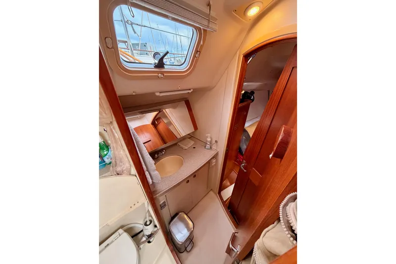 Slide: The Image of Interior of 2002 Hunter 460 sailboat bathroom with sink and wooden cabinetry. - 55