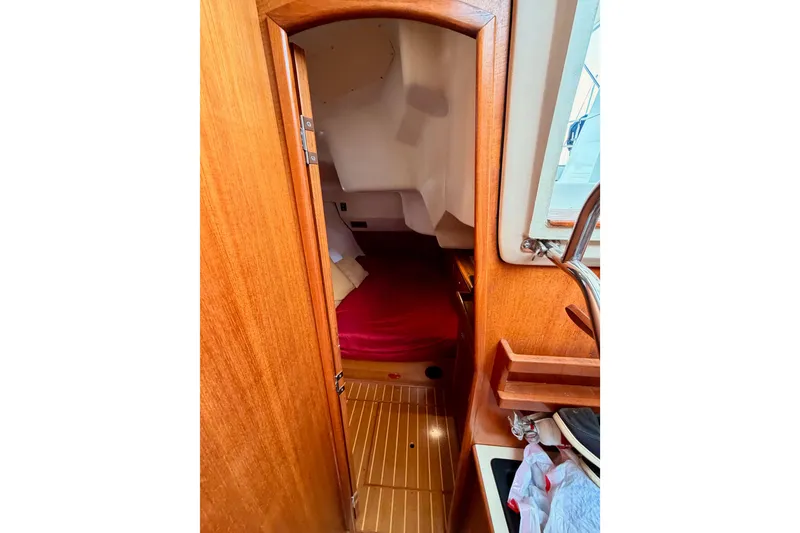 Slide: The Image of Interior cabin view of a 2002 Hunter 460 sailboat with wooden finish. - 56