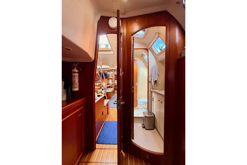 Slide: The Image of Interior of 2002 Hunter 460 yacht showing bathroom and cabin area. - 61