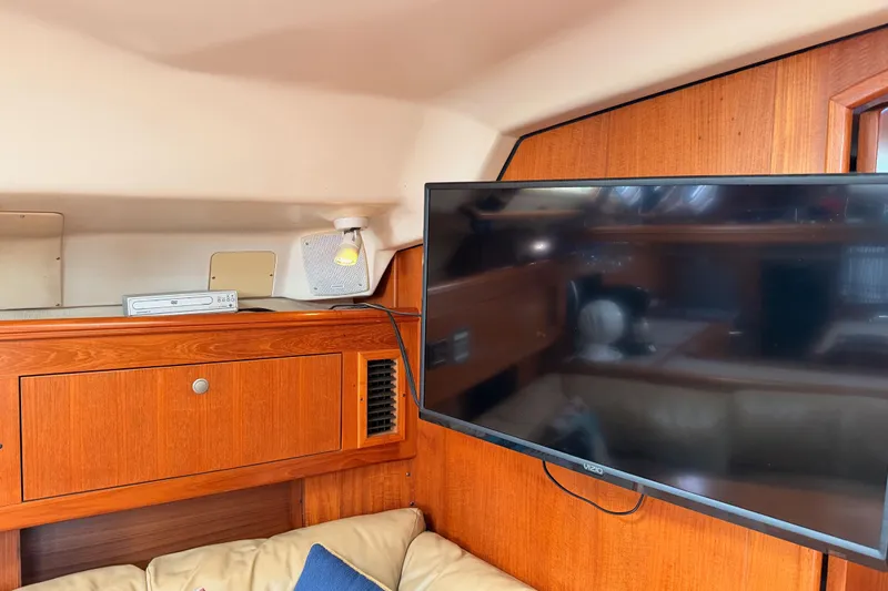 Slide: The Image of Interior of 2002 Hunter 460 yacht with TV and wooden cabinetry. - 67