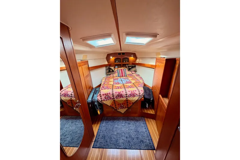 Slide: The Image of Cozy cabin interior of 2002 Hunter 460 sailboat with colorful bedding and wooden finishes. - 70