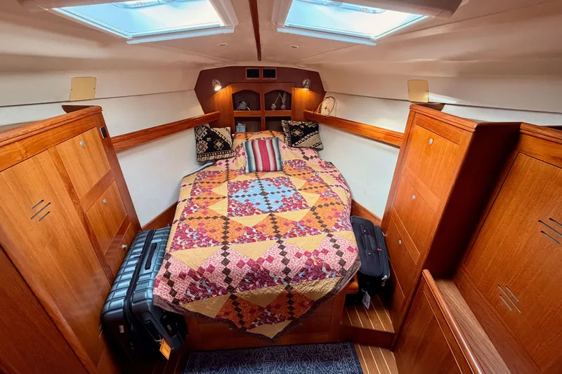 Slide: The Image of Cozy cabin interior of 2002 Hunter 460 sailboat with colorful quilted bedspread. - 71