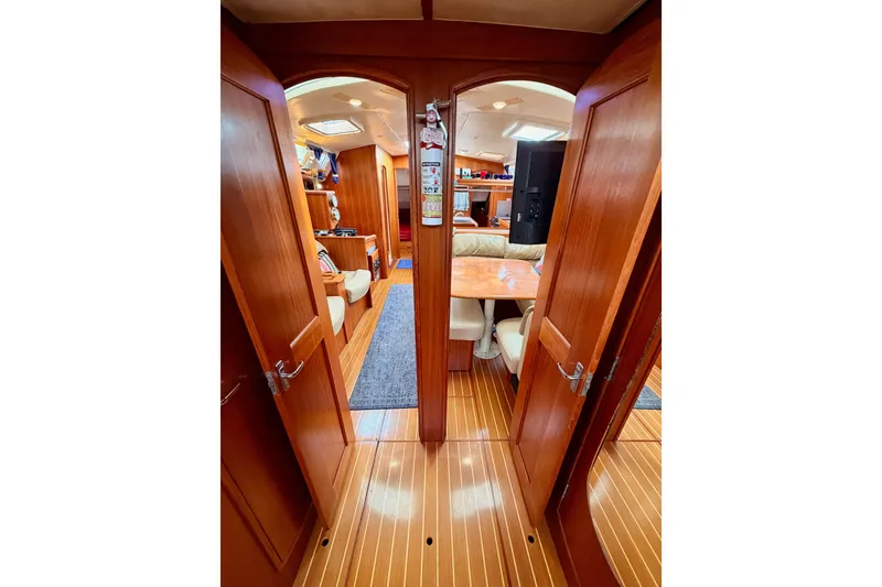 Slide: The Image of Interior of 2002 Hunter 460 yacht with wooden finish and cozy seating area. - 76