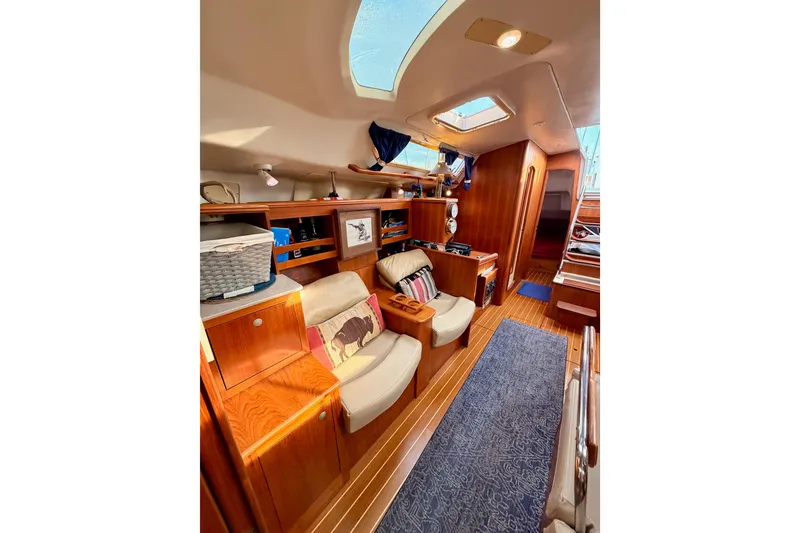 Slide: The Image of Interior of 2002 Hunter 460 yacht with cozy seating and wooden cabinetry. - 77