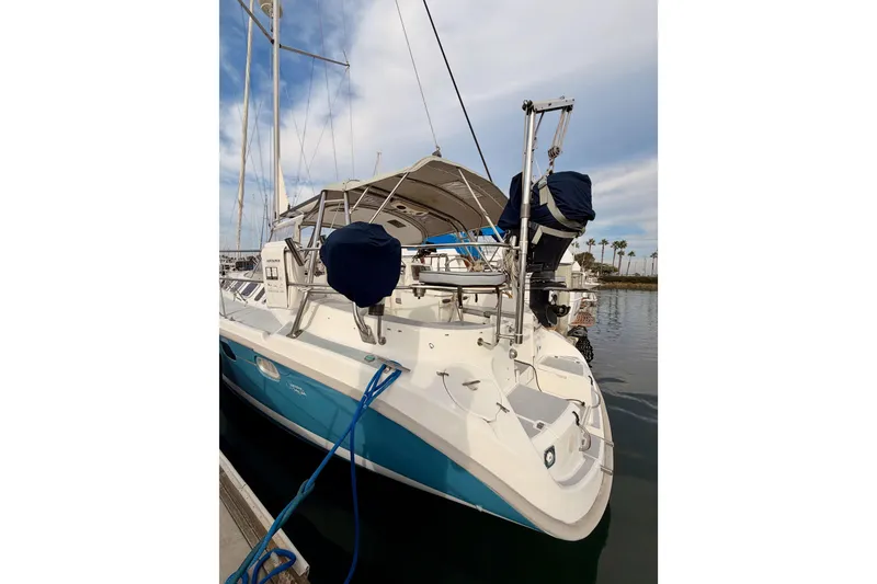 Slide: The Image of 2002 Hunter 460 sailboat docked, featuring a sleek design and blue hull. - 8