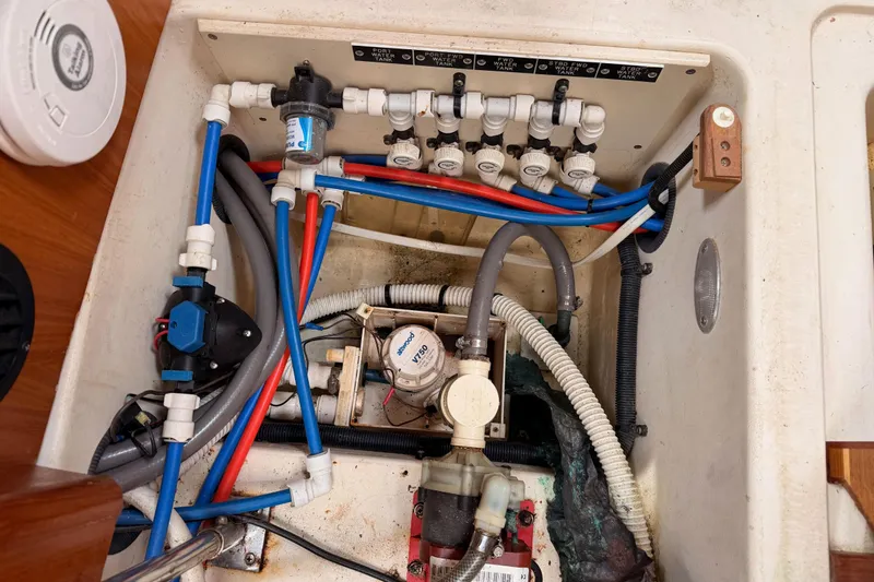 Slide: The Image of Plumbing system of a 2002 Hunter 460 boat, featuring pipes and valves. - 82