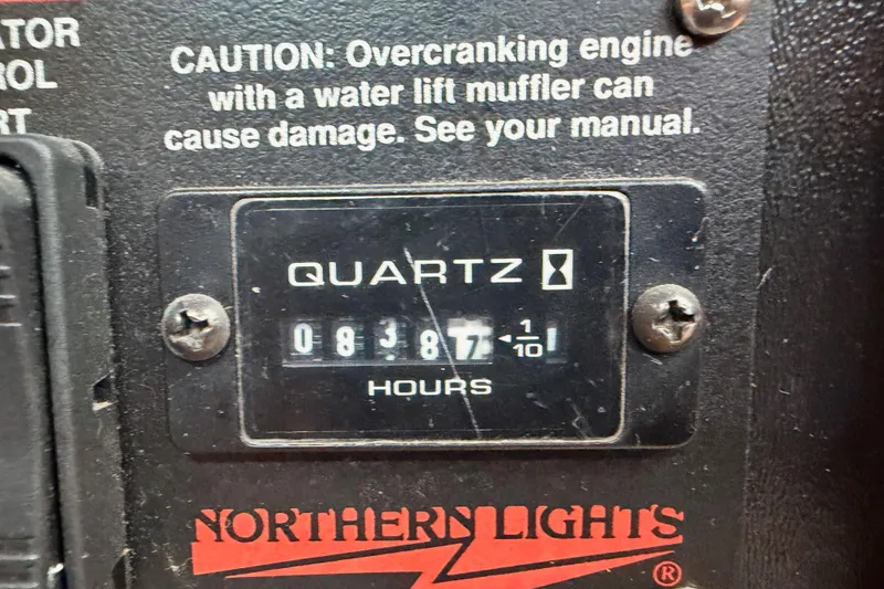 Slide: The Image of Hour meter on Northern Lights engine panel, showing 8387.1 hours, with caution text above. - 84