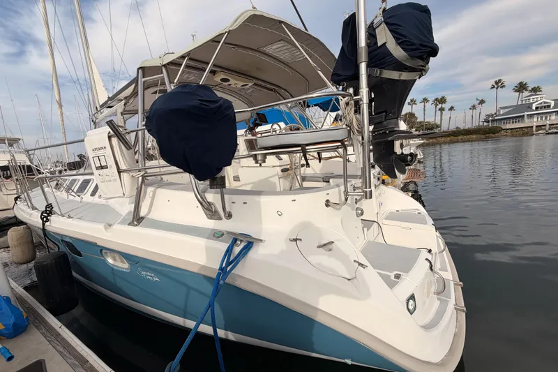 Slide: The Image of 2002 Hunter 460 sailboat docked at marina, featuring blue and white hull. - 9