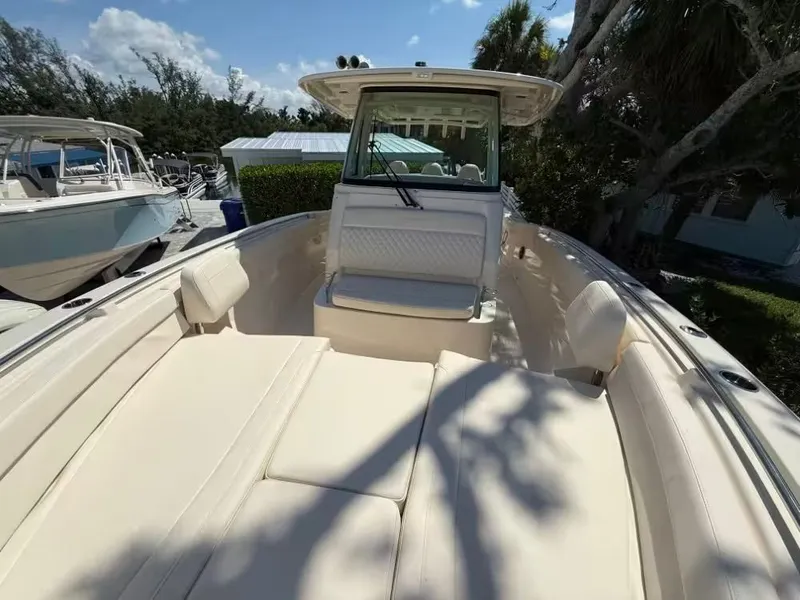 Slide: The Image of 2026 Grady-White Canyon 326 boat with spacious seating and sleek design under a clear sky. - 10