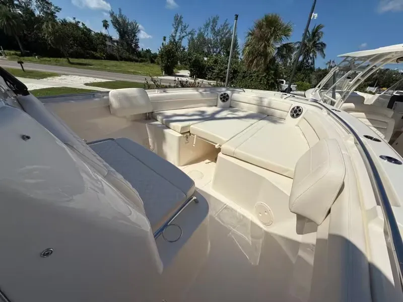 Slide: The Image of 2026 Grady-White Canyon 326 boat interior with cushioned seating and speakers. - 11